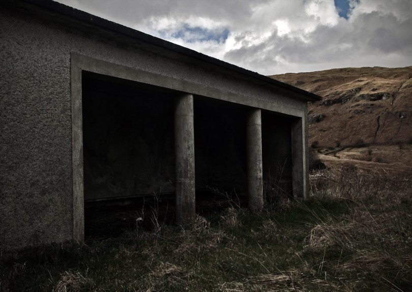 The utilitarian concrete playground shelter of the grassy school yard. Glensaul National School, Greenaun townland, Co. Mayo (c.1950)