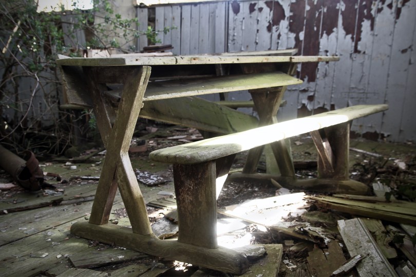 A school desk, bathed in light inside the old classroom