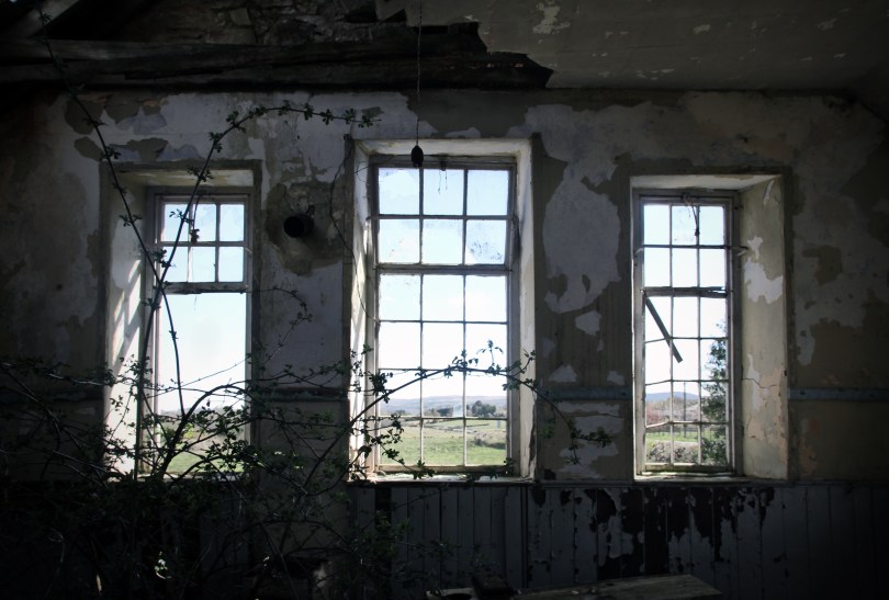 The tall 'six-over-twelve' windows in the gable end of the school house